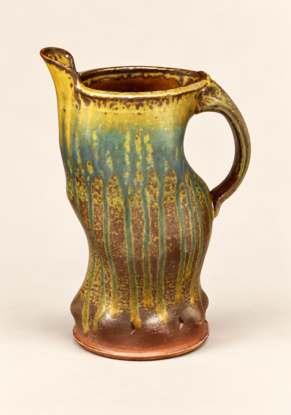Tall amber and green glazed pitcher