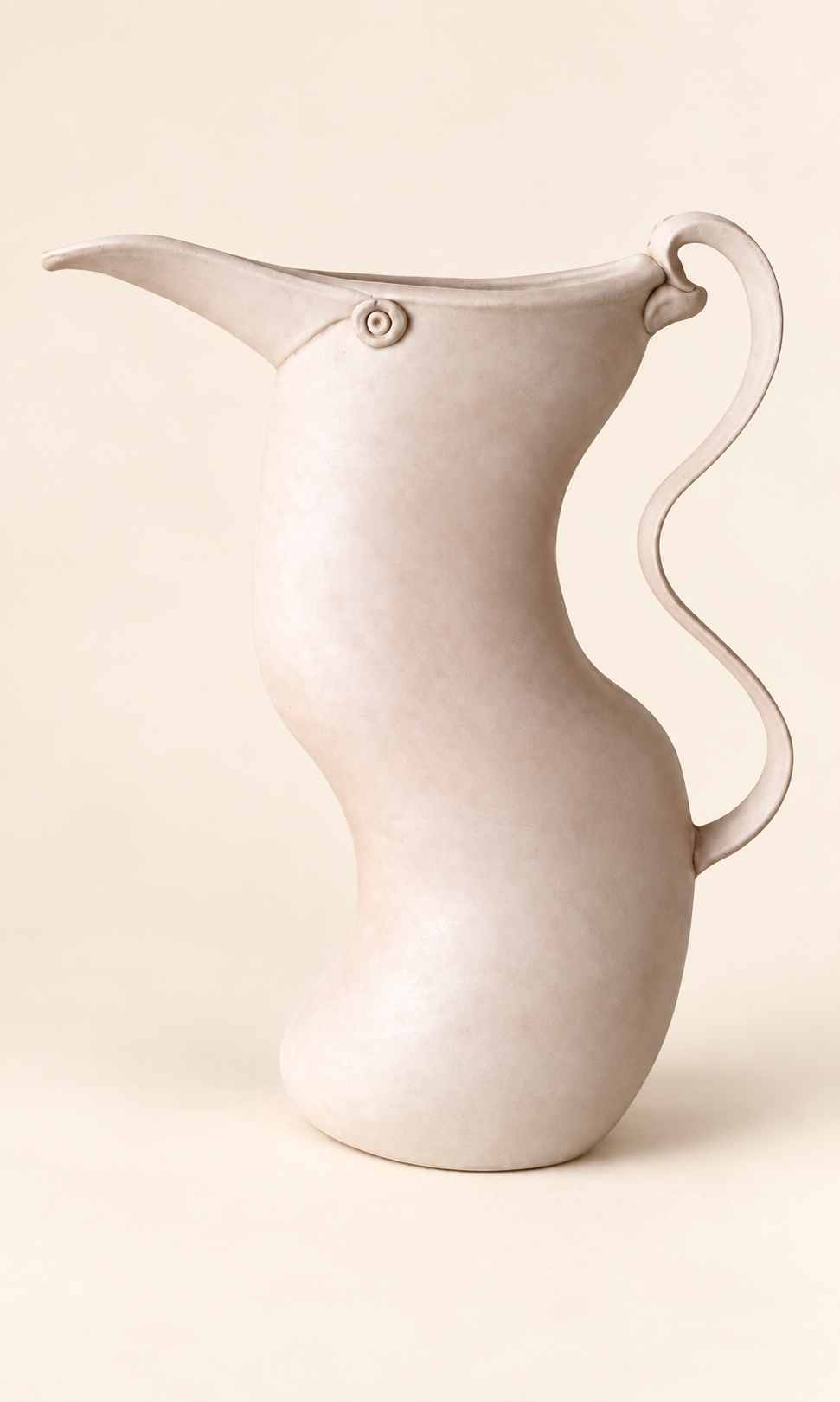 Pale sculptural pitcher with long curved spout and wavy handle